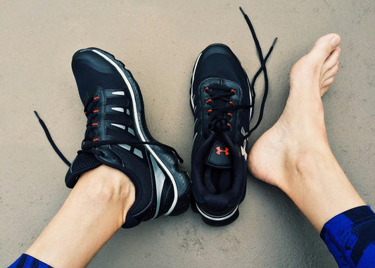 pair of feet with running shoes plantar fasciitis